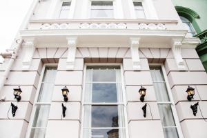 a white building with lights in the window at The Rosewood Torquay in Torquay