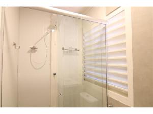 a bathroom with a shower with a glass door at Hotel Rio de Pedras in Itabirito