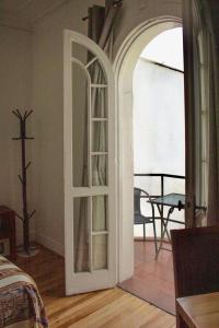 a room with a wooden floor and a wooden door at Hotel De Blasis & Cowork in Santiago