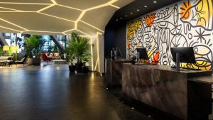 a lobby with a colorful mural on the wall at M Social Hotel Times Square New York in New York