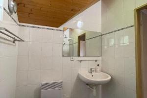 a white bathroom with a sink and a mirror at Ski Chalet Escape in Javorník in Rudník +32 photos