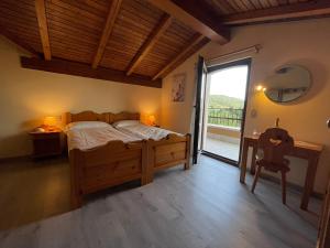 a bedroom with a bed and a table and a window at Hotel Monte Baldo in Brenzone sul Garda