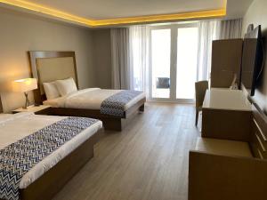 a hotel room with two beds and a television at All Inclusive- Divi Carina Bay Beach Resort & Casino Adult Only in Madame Carty