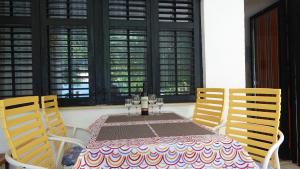 a table with two chairs and a table with wine glasses at 35 meters from sea Apartment Keser and House for rent in Karlobag