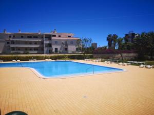a large swimming pool in front of a building at Dunas Mar in Alvor