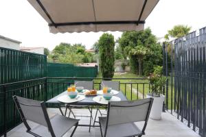 a patio with a table and chairs on a balcony at T2 avec terrasse / 10mn grande plage in Royan