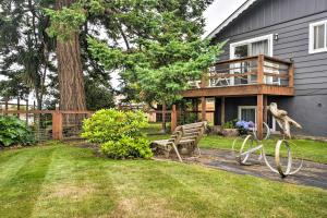 a yard with a bench and a house at Brookings Vacation Rental Studio - Walk to Town! in Brookings