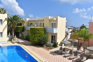 a view of a villa with a swimming pool at Mediterranea Apartments in Kato Daratso