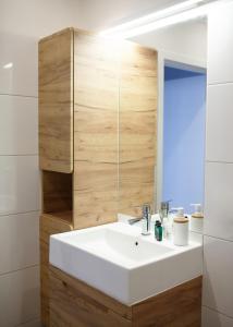a bathroom with a white sink and a mirror at See U in Szczecin in Szczecin