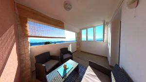 a small living room with a table and chairs at Apartments Matteo in Omišalj