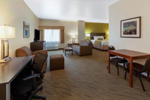 a hotel room with a bed and a desk and a room at Baymont by Wyndham Beulah in Beulah
