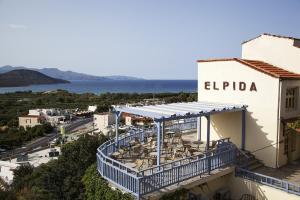 a building with tables and chairs on a balcony at Elpida Village in Istro