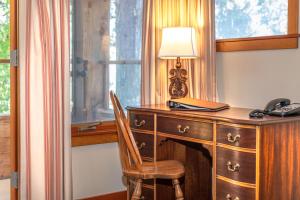 a wooden desk with a lamp and a telephone at Hastings House Country House Hotel in Ganges
