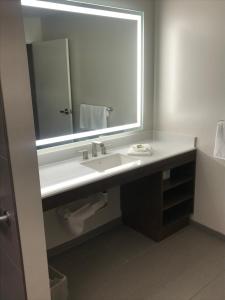 a bathroom with a sink and a mirror at Inn at Rohnert Park in Rohnert Park +11 photos