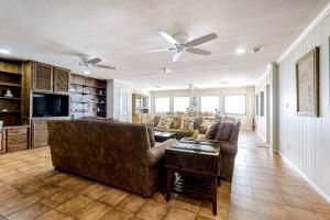a living room with a couch and a ceiling fan at Anchors Away at North Shore in Port Isabel