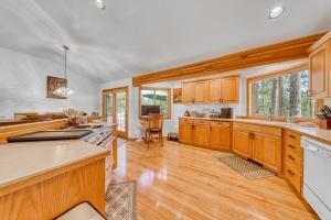 a kitchen with wooden cabinets and wooden flooring at Sunset Mountain Retreat in Sunriver