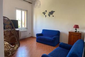 a living room with a blue chair and a tv at KB House in Pula