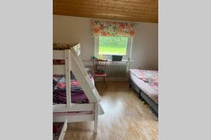 a bedroom with two bunk beds and a window at Summer in the North of Sweden in Bjurholm +10 photos