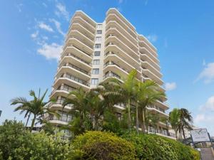 a tall building with palm trees in front of it at Seaview 31 Luxurious Beachside Two Bedroom Apartment in Seaview Resort with Stunning Views in Mooloolaba