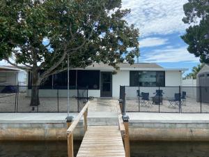 a house with a wooden dock in the water at Gorgeous Seaside Seashell Cottage! in Hudson