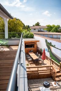 a deck with a table and chairs on a house at Frenchyhomes☆villadeluxe☆Plage☆piscine in Andernos-les-Bains