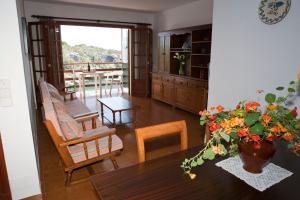 a living room with a table and chairs at Apartamentos Llevant in Cala Figuera