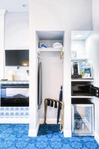 a kitchen with white walls and a blue floor at The Hudson Whaler in Hudson