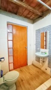 a bathroom with a toilet and a sink at Casa de Campo Villa Marcara in Marcará