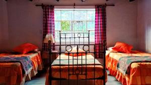 Katil atau katil-katil dalam bilik di Casa de Campo Villa Marcara