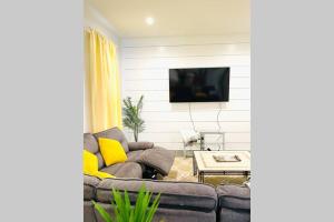 a living room with a couch and a tv at Luxurious Home for Families & Professionals in Mount Holly