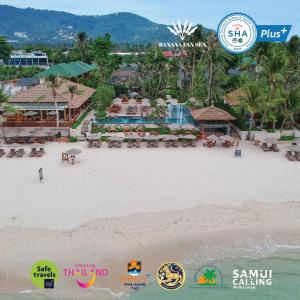 a beach filled with lots of different types of surfboards at Banana Fan Sea Resort - SHA Extra Plus Certified in Chaweng