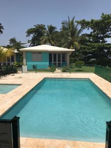 a swimming pool in front of a house at Beautiful Ocean Front Villa in Aguada