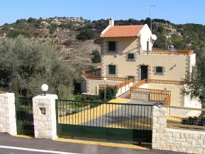 a house with a fence in front of it at Stratos Villas in Kaloniktis