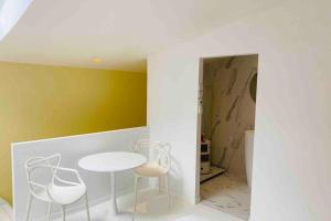 a dining room with a table and two chairs at L’adoré Sainte Catherine in Bordeaux