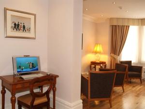 a hotel room with a desk with a computer on it at The Redstone Guesthouse in Blackpool