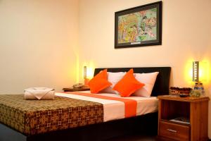 A bed or beds in a room at Helios Hotel Malang