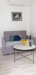 a living room with a table and a couch at Maestral in Orebić