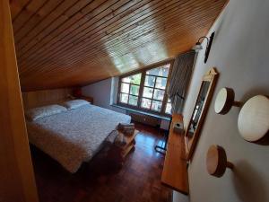 a bedroom with a bed and a large window at Mansarda condominio Royal in Valtournenche