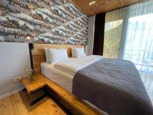 A bed or beds in a room at Vache Hotel