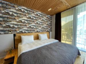 A bed or beds in a room at Vache Hotel