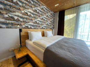 A bed or beds in a room at Vache Hotel