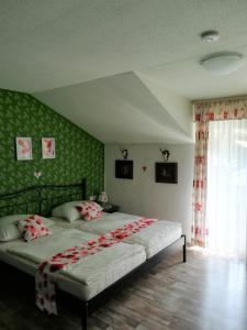 a bedroom with a large bed with red and white pillows at Apartment Christopherhof 11, Grafenwiesen in Grafenwiesen