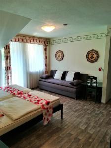 a living room with a bed and a couch at Apartment Christopherhof 11, Grafenwiesen in Grafenwiesen