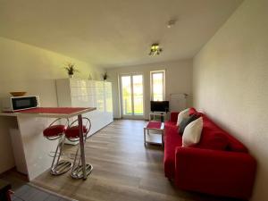 a living room with a red couch and a table at Apartment- Singen Überlinger Straße in Singen