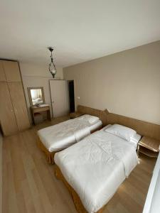 A bed or beds in a room at EVİM APART HOTEL