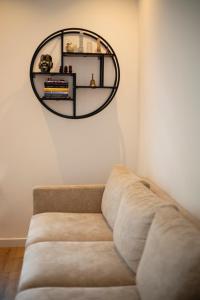 a couch in a room with a mirror on the wall at Beautiful family house 5 min away from Amsterdam in Badhoevedorp