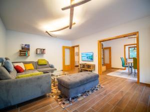 a living room with a couch and a table at Rheintal-Ferien - 90 qm Ferienwohnung mit Wine & Style - Dein Urlaub am Rhein in Niederheimbach +20 photos