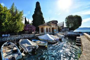 a group of boats are docked in a harbor at Taverna Affittacamere in Gardone Riviera