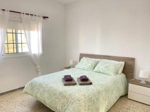 A bed or beds in a room at Apartamentos Los Arroyos