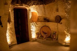a room with a door and two vases on the floor at Pome Granate Cave Hotel in Nevşehir +53 photos